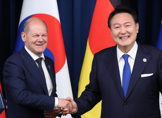 윤석열 대통령과 올라프 숄츠 독일 총리가 21일 서울 용산 대통령실에서 한독 정상회담 공동 기자회견을 마친 뒤 밝게 웃으며 악수하고 있다. 연합뉴스